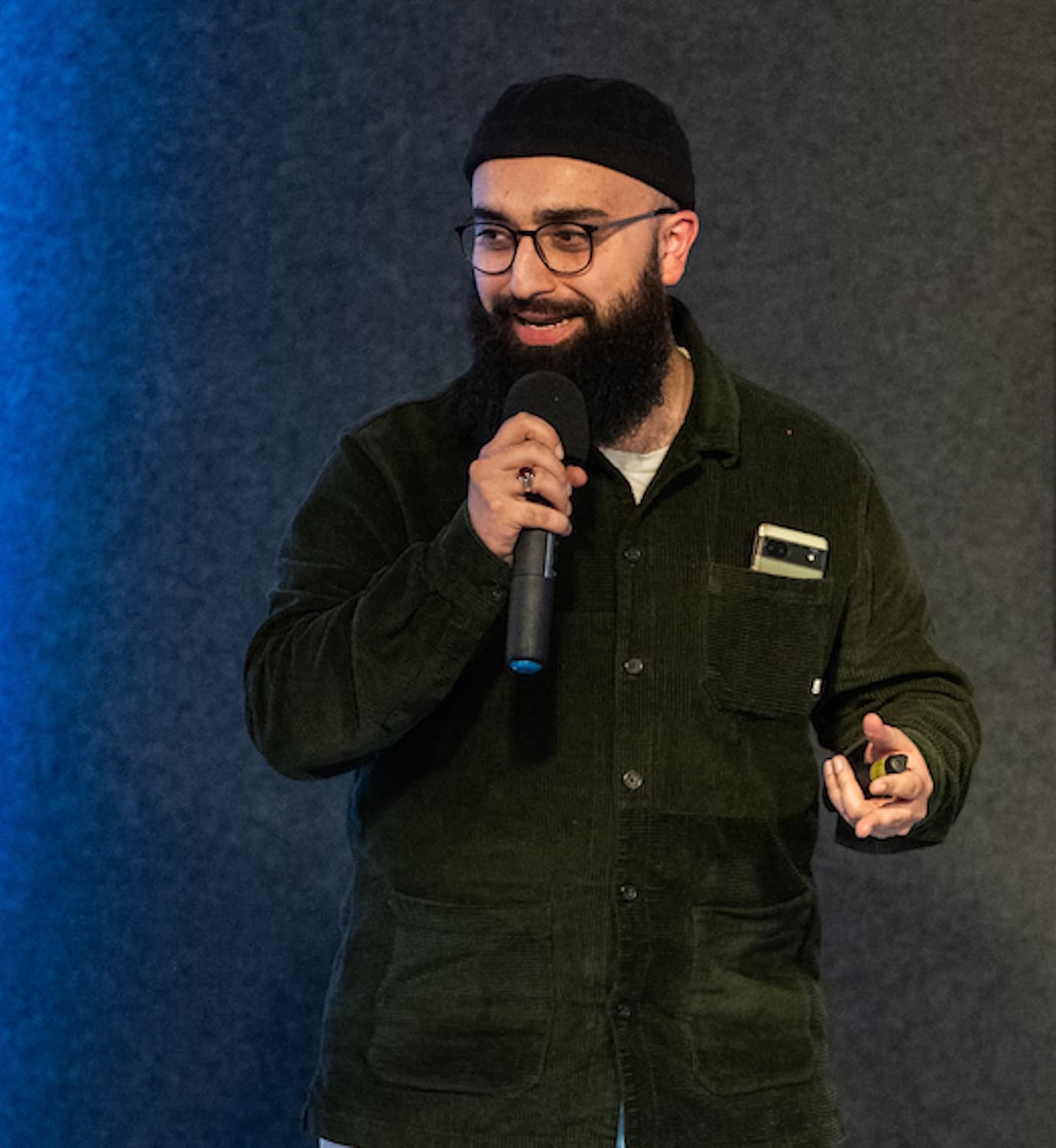 Technical speaker presenting to an audience with a microphone