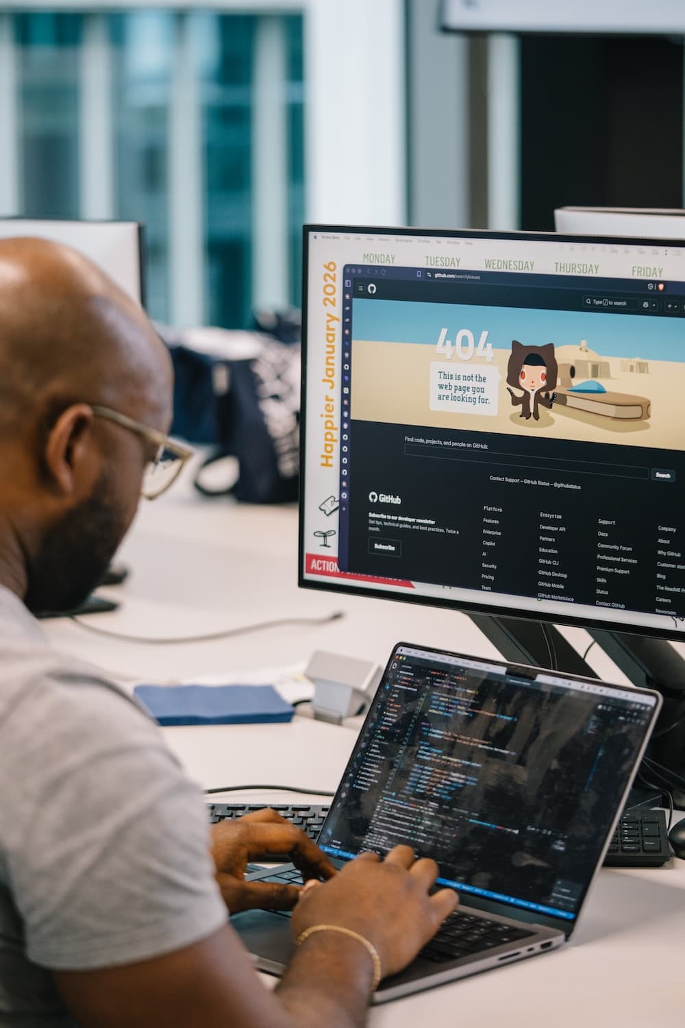 Software developer working across a web browser and code editor